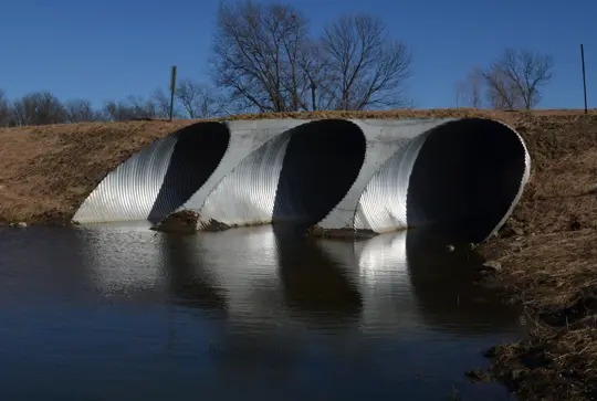 A large culvert made from corrugated metal pipe.