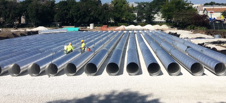 Installation of a Contech corrugated metal pipe stormwater detention system.