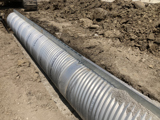 Inside view of corrugated metal pipe. 