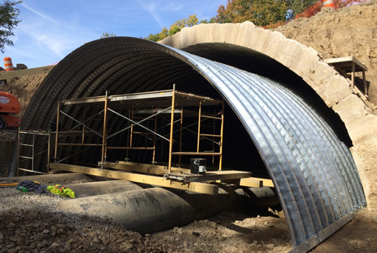 A tunnel being relined with structural plate. 