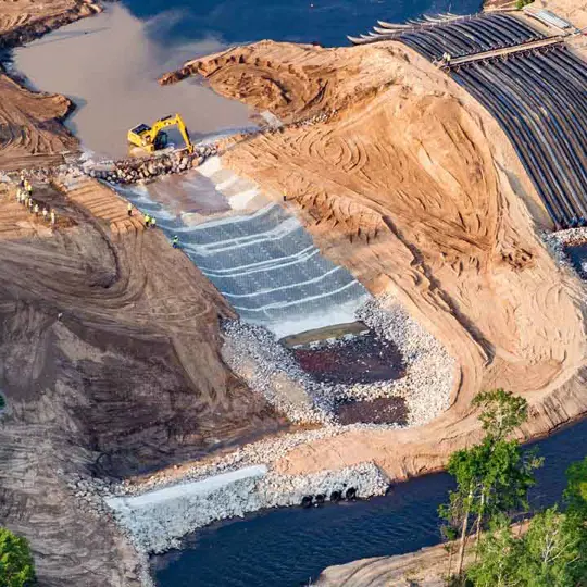 A dam spillway is being lined with Armorflex cellular concrete blocks.