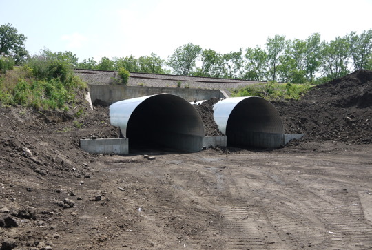 Relining a culvert under a rail line with structural plate. 