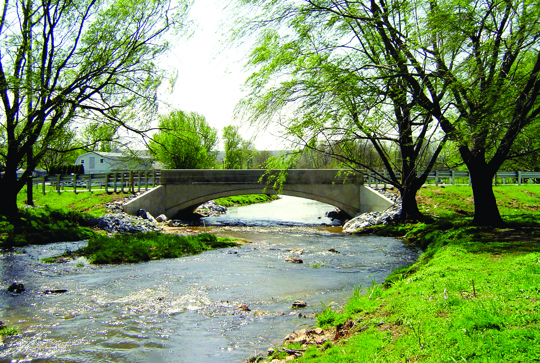 An bridge over a stream made from the CON/SPAN precast modular bridge system.