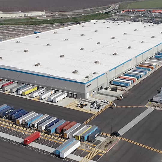  A large warehouse and parking lot with impervious surfaces. 