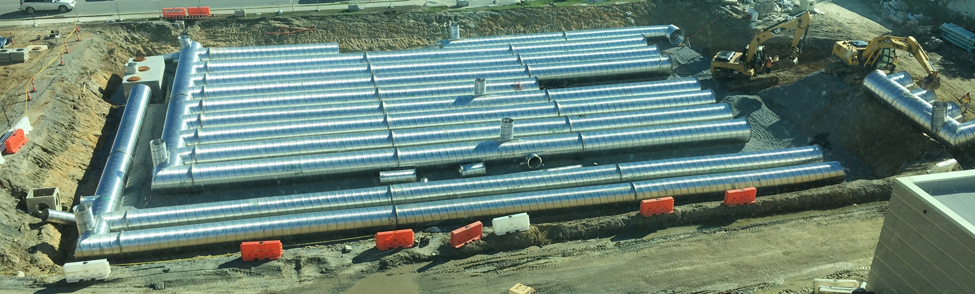 Installation of a Contech corrugated metal pipe stormwater detention system.