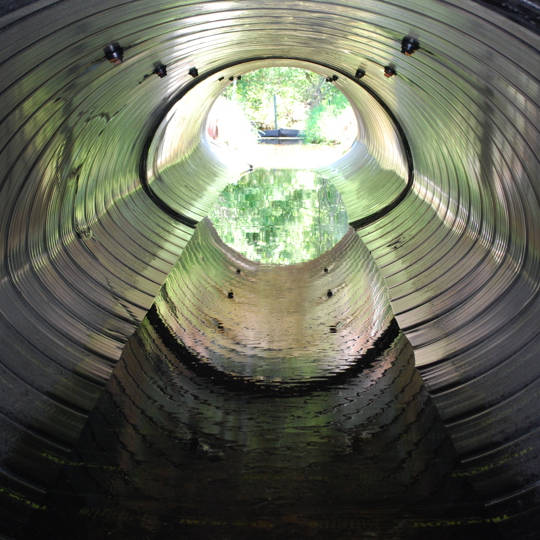 A culvert made from Smooth Cor corrugated metal pipe. 