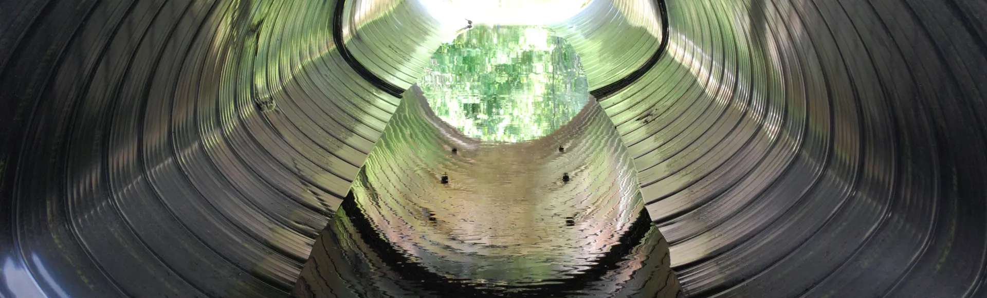 A culvert made from Smooth Cor corrugated metal pipe.