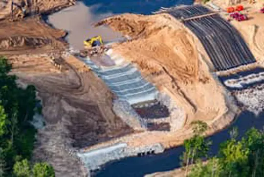 A dam spillway is being lined with Armorflex cellular concrete blocks.