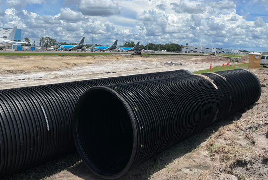 Installation of DuroMaxx steel-reinforced polyethylene (SRPE) pipe at an airport. 
