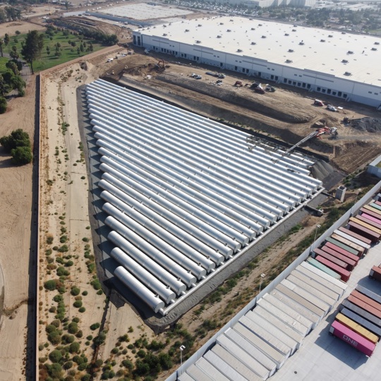 An aerial view of a large corrugated metal pipe stormwater underground detention system. 