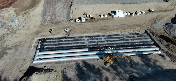 Installation of a corrugated metal pipe detention system. 