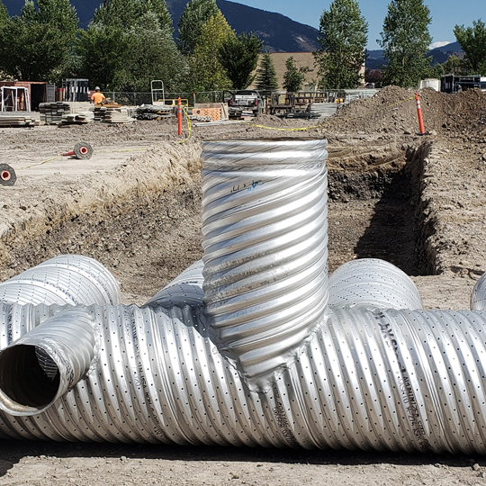 A corrugated metal pipe stormwater detention system under construction. 