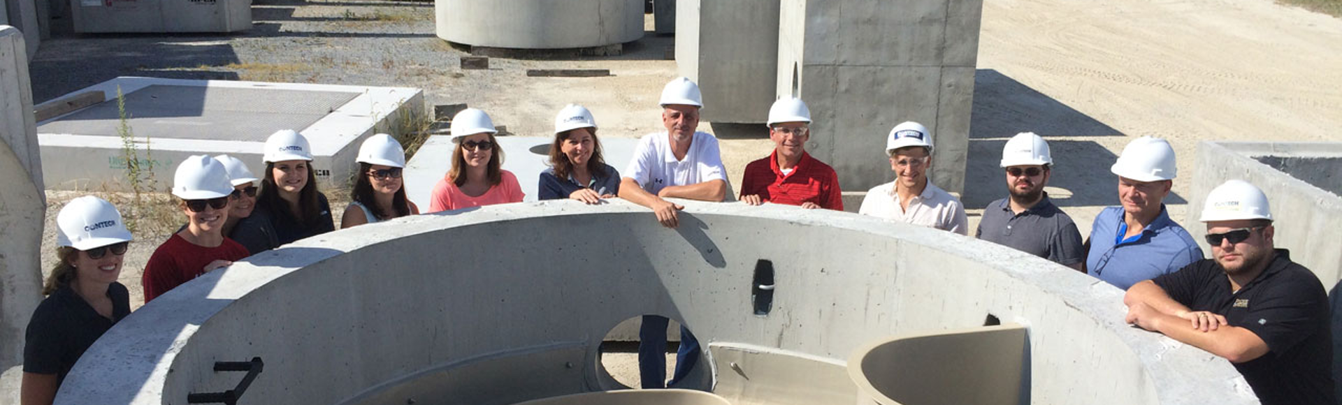 Contech employees surround a Jellyfish Filter stormwater filtration device. 