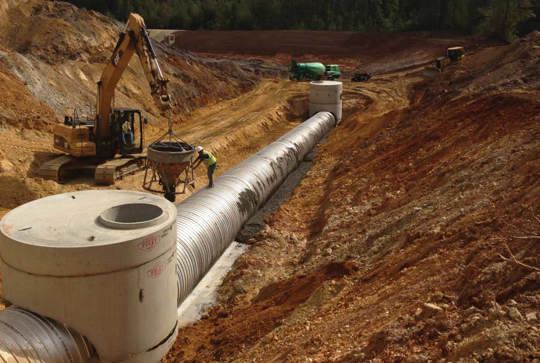 A storm sewer under construction made from Contech corrugated metal pipe. 