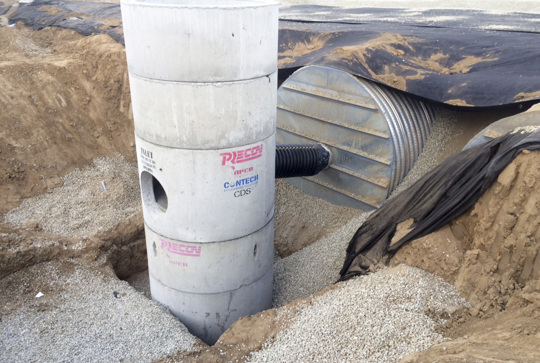 Installation of a CDS hydrodynamic separator to pretreat a corrugated metal pipe stormwater detention system. 
