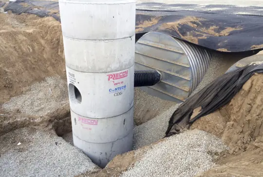 Installation of a CDS hydrodynamic separator to pretreat a corrugated metal pipe stormwater detention system.