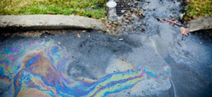 Stormwater on a road with an oil slick.