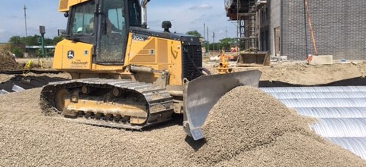 image bulldozer backfilling CMP pipe