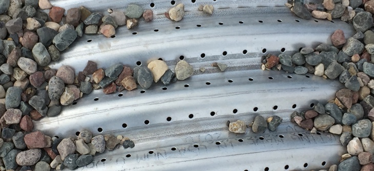 Perforated corrugated metal pipe.