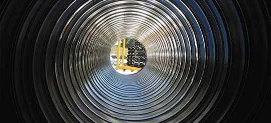 Inside view of corrugated metal pipe. 