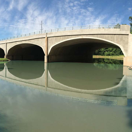 A CON/SPAN O-Series precast modular bridge over a river. 